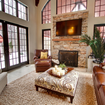 Innovative-Coral-Ottoman-mode-Indianapolis-Traditional-Family-Room-Decorating-ideas-with-arched-window-area-rug-beige-brown-leather-club-chair-fire-screen-Fireplace-large-windows